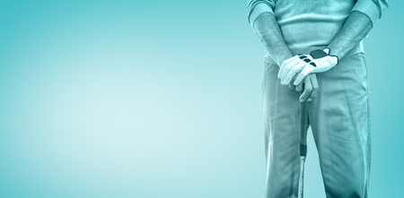 Golf player posing against blue vignette backgroundの写真素材
