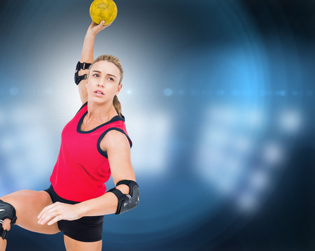 Female athlete throwing handball against composite image of spotlightの写真素材
