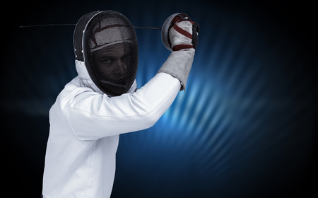 Man wearing fencing suit practicing with sword against black glowing design