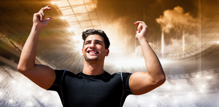 Portrait of happy sportsman  against view of a stadium