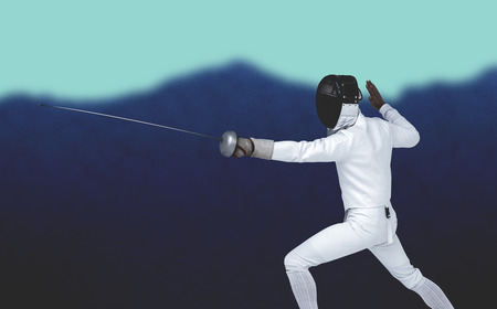 Man wearing fencing suit practicing with sword against blurred mountains