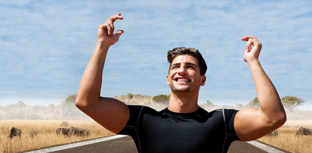 Portrait of happy sportsman  against savannah road landscapeの写真素材