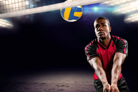 Composite image of sportsman playing volleyball against view of spotlightsの写真素材