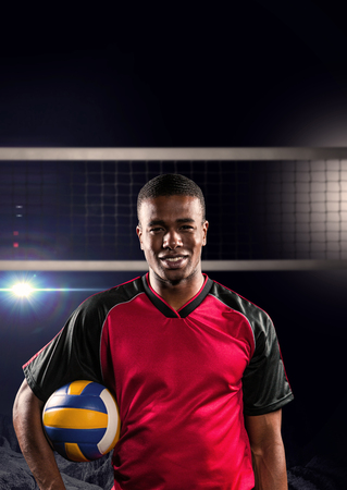 Sportsman holding a volleyball against view of lightingの写真素材