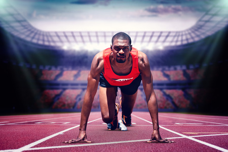 Composite image of athlete man in the starting block in a stadium