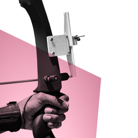 Focus on hand doing archery against rosa and whiteの写真素材