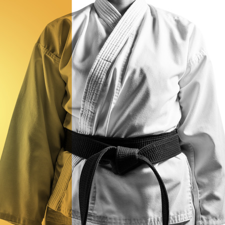Mid section of karateka against yellow vignetteの写真素材