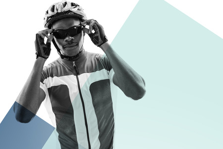 Portrait of cyclist is posing  against colored background