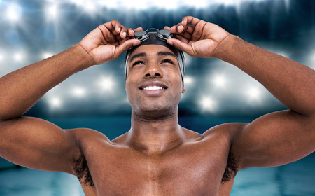 Swimmer ready to dive against view of swimming poolの写真素材
