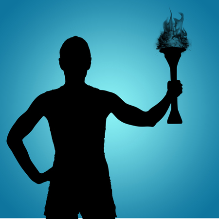 Rear view of sporty woman holding torch against blue vignette backgroundの写真素材