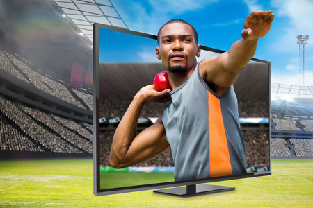 Front view of sportsman practising shot put  against digital image of a stadium