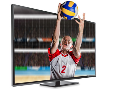 Sportsman catching a volleyball while playing against composite image of outdoor playing field