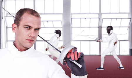 Close-up of swordsman holding fencing sword against gym