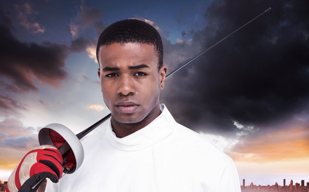 Portrait of swordsman holding sword against city on the horizonの写真素材