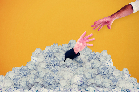Businessman holding hand out against white background with vignetteの写真素材