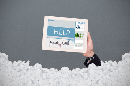 Masculine hand holding tablet against white background with vignetteの写真素材