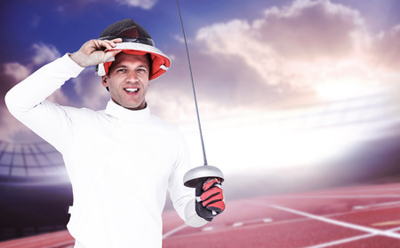 Man wearing fencing suit practicing with sword against race track