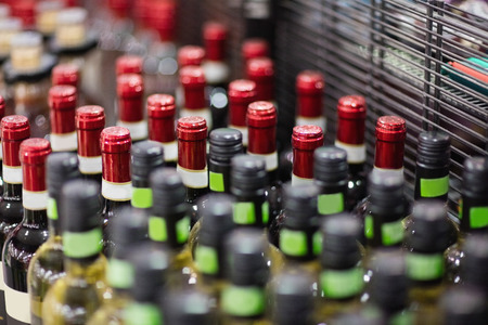 Close up of red and white wine bottles on a grocery