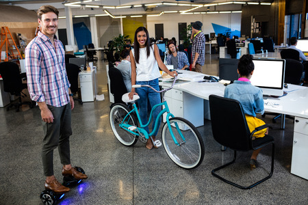 Hipsters with bicycle and smart board in the officeの写真素材
