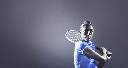 Tennis player playing tennis with a racket against grey vignette