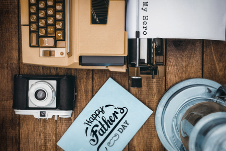 fathers day greeting against view of an old typewriter and cameraの写真素材