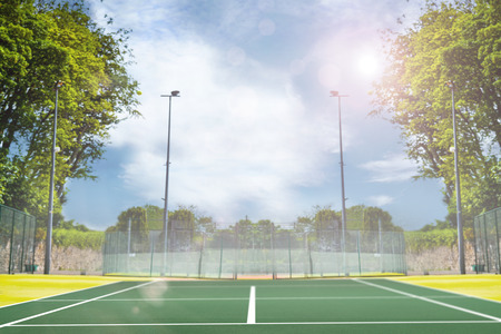 Focus of tennis field  against composite image of tennis field on a sunny dayの写真素材