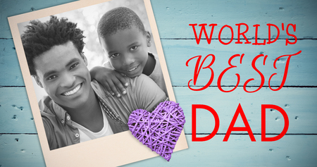 Father opening gift given by children against overhead of wooden planksの写真素材