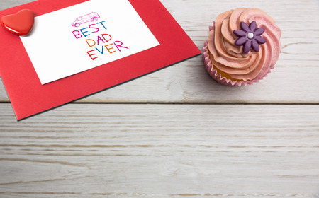 Word best dad ever against delicious cupcakes on a tableの写真素材