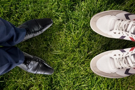 Businessman standing isolated on white background against grass backgroundの写真素材