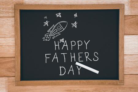 Happy fathers day against chalkboard on deskの写真素材