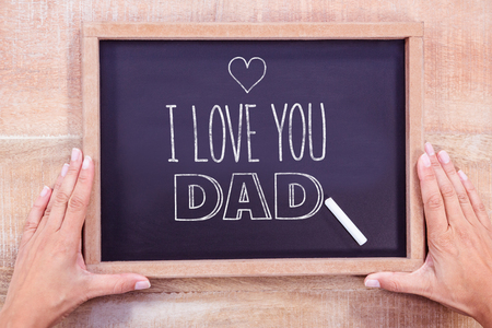 fathers day greeting against hand writing on chalkboardの写真素材