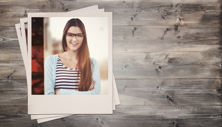Young creative worker smiling at camera against bleached wooden planks backgroundの写真素材