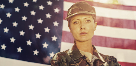 Portrait of soldier standing in front of american flagの写真素材
