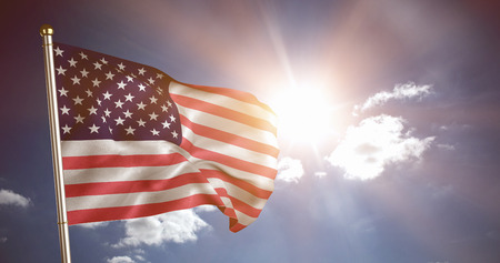 Close up of the us flag against cloudy sky with sunshineの写真素材