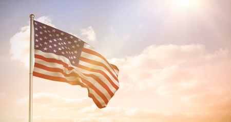 Close up of the us flag against colored sky with cloudsの写真素材