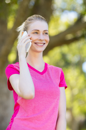 Woman talking on mobile phone in parkの写真素材
