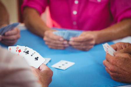 Retired people playing card in a retirement homeの写真素材