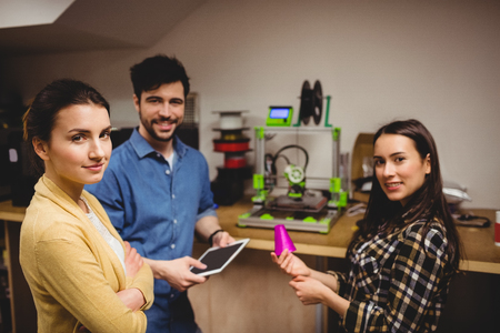 Portrait of graphic designers standing in office