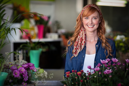 Portrait of happy female florist in flower shopの写真素材