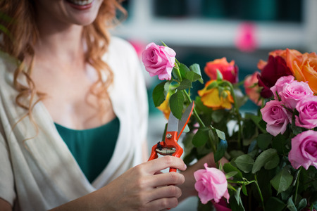 Female florist preparing flower bouquet in flower shopの写真素材