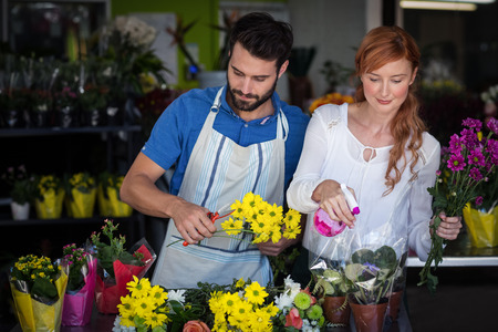 Couple preparing flower bouquet in the flower shopの写真素材
