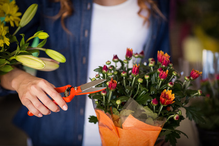 Female florist preparing flower bouquet in the flower shopの写真素材