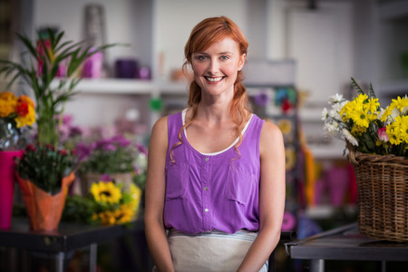 Portrait of female florist smiling in the flower shopの写真素材