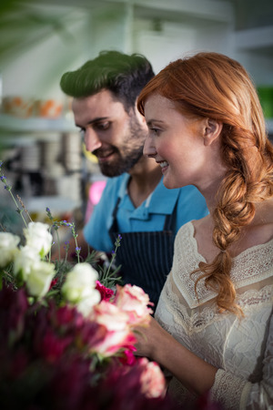 Happy couple arranging flowers in the flower shopの写真素材