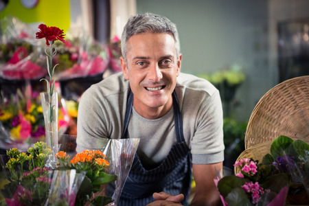 Portrait of happy male florist at his flower shopの写真素材