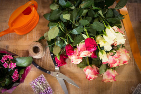 Close-up of bouquet of flower material on a wooden worktopの写真素材