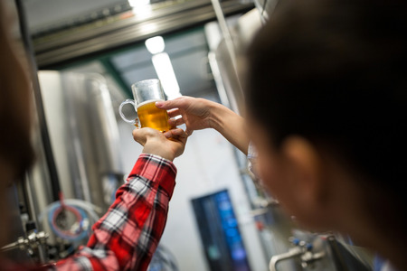 Brewers testing beer at breweryの写真素材