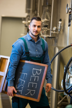 Portrait of bewer holding placard at beweryの写真素材
