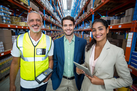Portrait of team is smiling and posing in a warehouseの写真素材