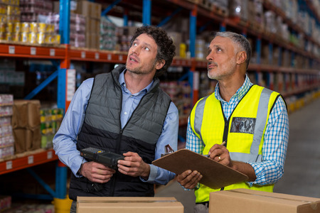 Portrait of managers are looking shelves in a warehouseの写真素材